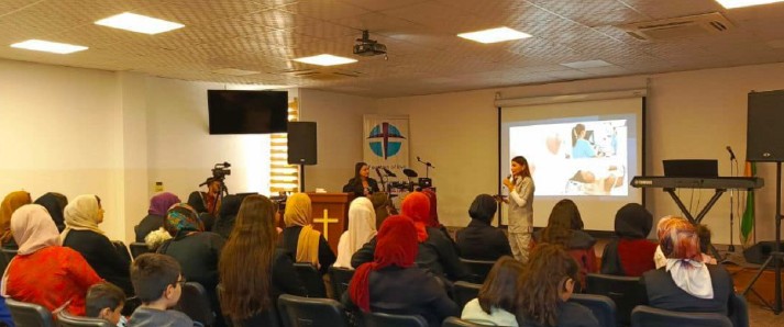 Women gathered in a church setting for a teaching session led by Celestine*
